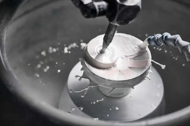 A Leica employee polishes lenses of a Leica spotting scope