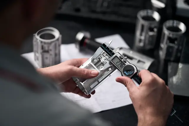 A Leica employee works on a Leica spotting scope