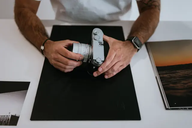 Leica camera salesperson displays Leica cameras