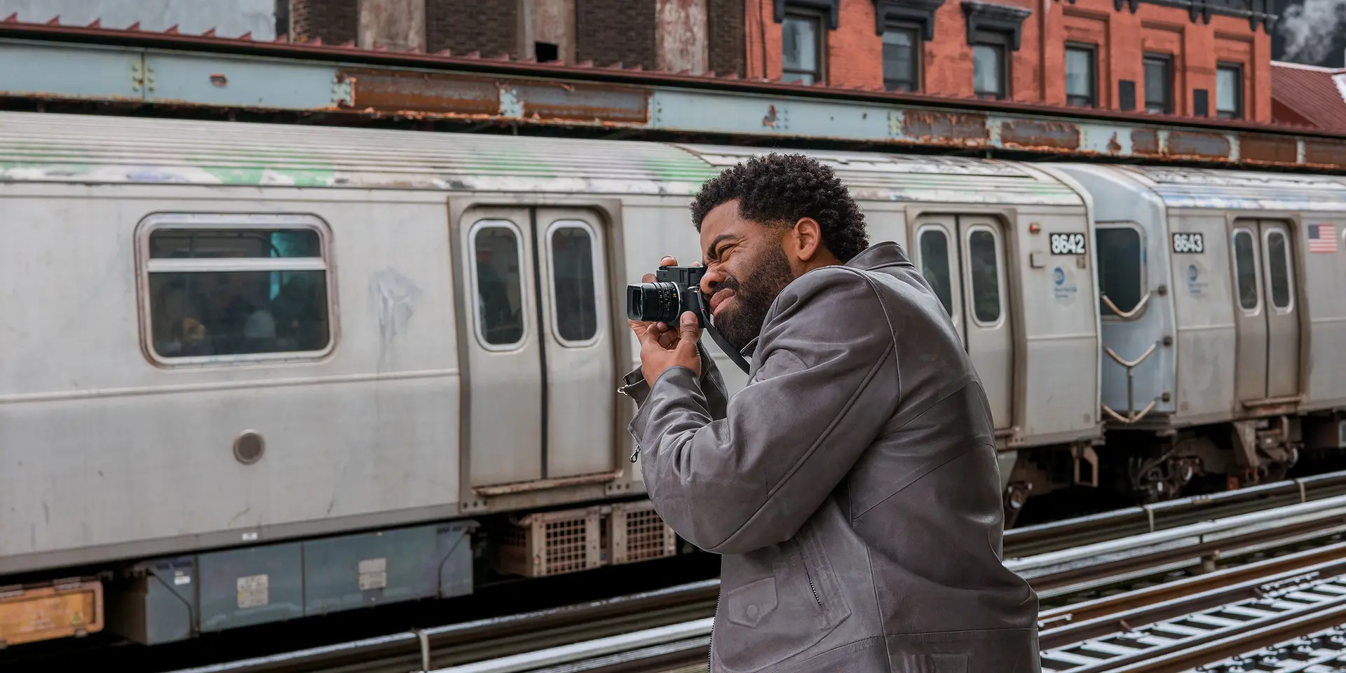 Man photographs a train with a Leica M11