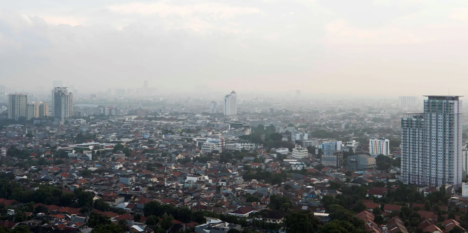 View of a foggy city with tower blocks.