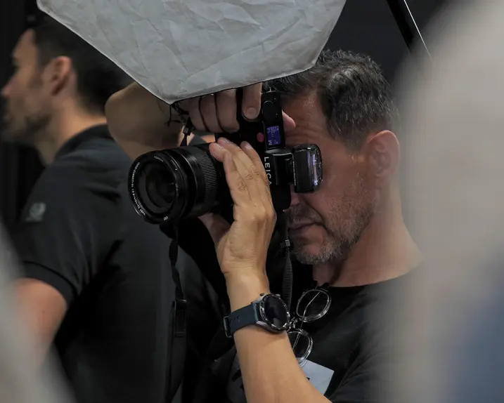 Close-up of a man taking a picture in a studio.