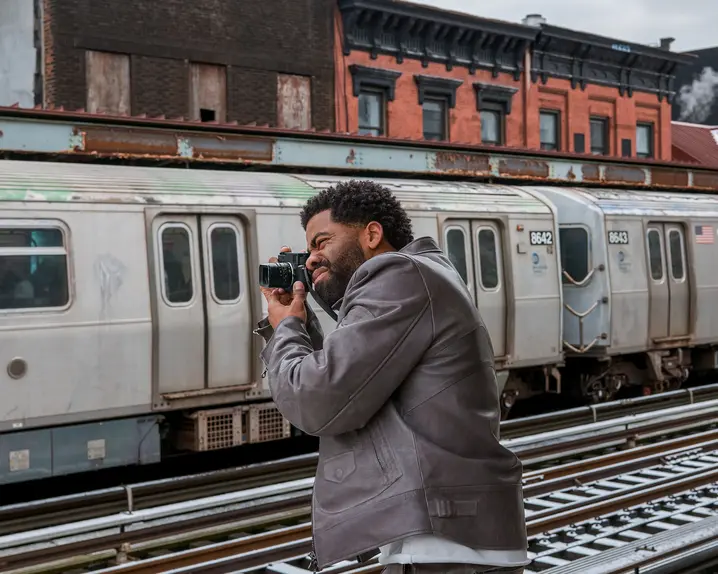 Man photographs a train with a Leica M11