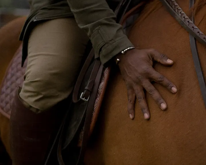 Close-up of a person sitting on a horse