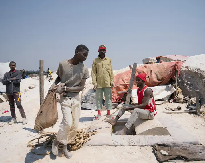People carrying sacks of minerals.