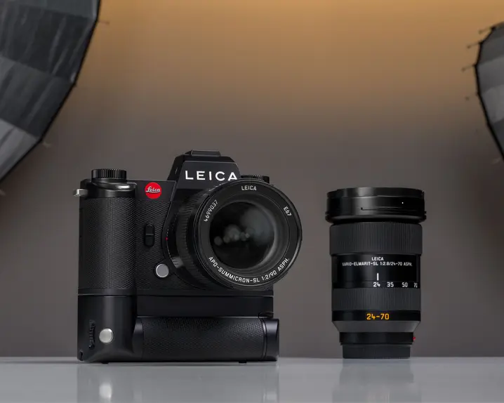 A Leica camera placed on a table in a photography studio setting