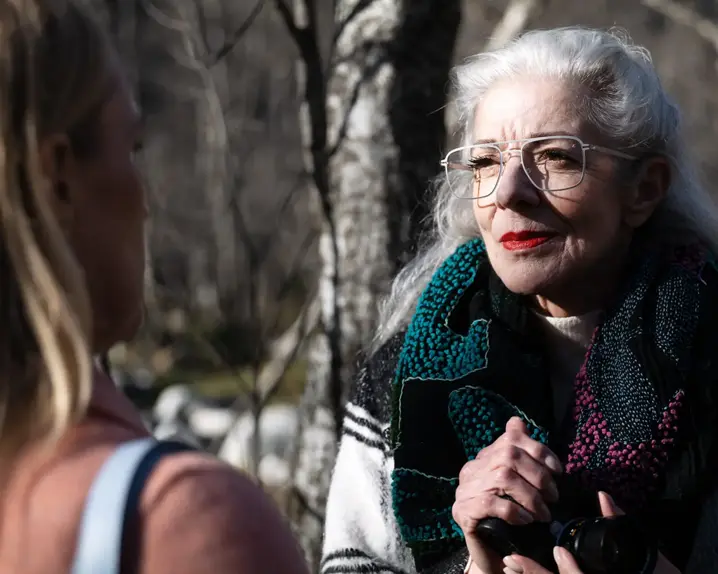 an elderly woman wearing glasses with Leica lenses