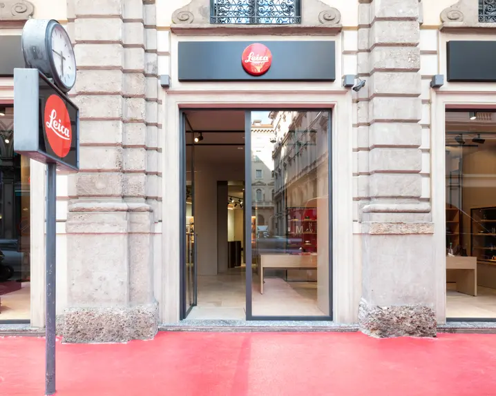 Entrance to a Leica Gallery with glass front and red Leica logo on a sign.