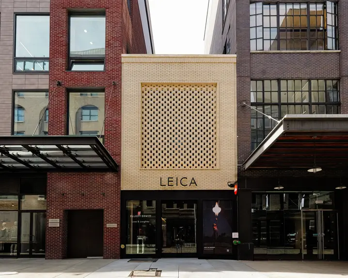 View of the entrance to a large building with the lettering ‘Leica’.