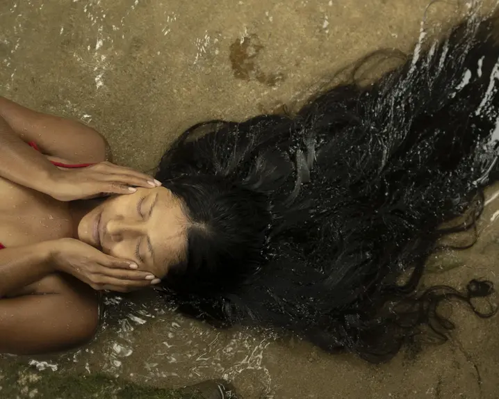 Woman with long brown hair laying in the sea