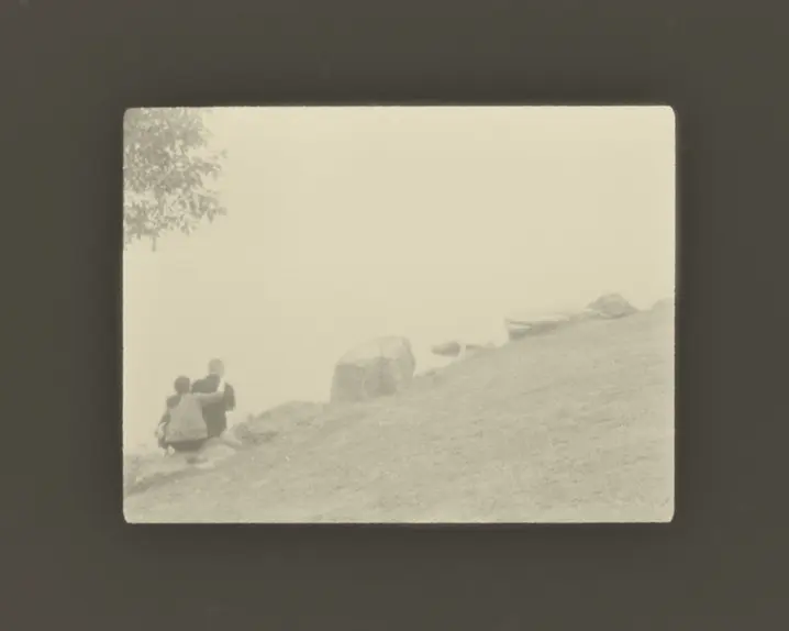 couple sitting hugging on large stones