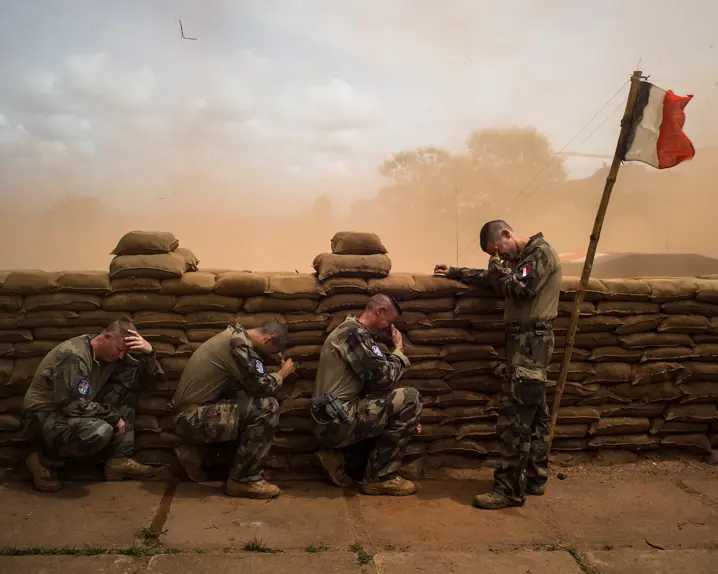 Weeping soldiers behind a wall