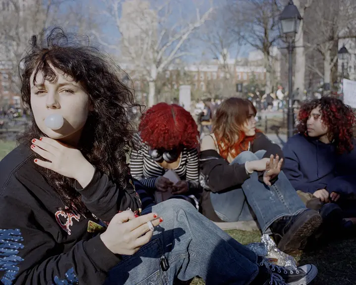 Teenage girl with chewing gum bubble