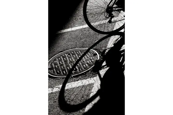 black and white photo shadow of a bicycle