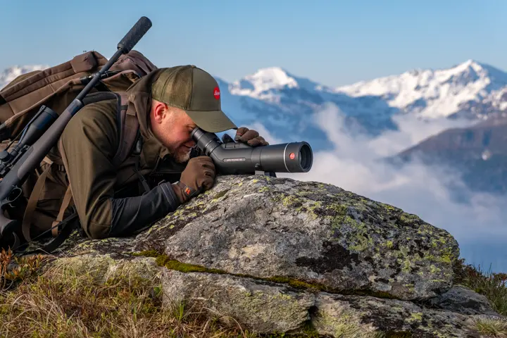 Man is looking through his Televid spotting scope