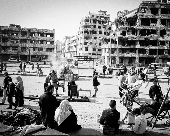Syria after the fall of the regime in 2024. Many people in front of old ruins