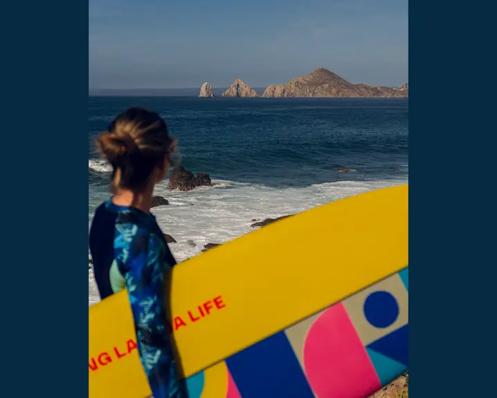 Woman with a surfboard under her arm