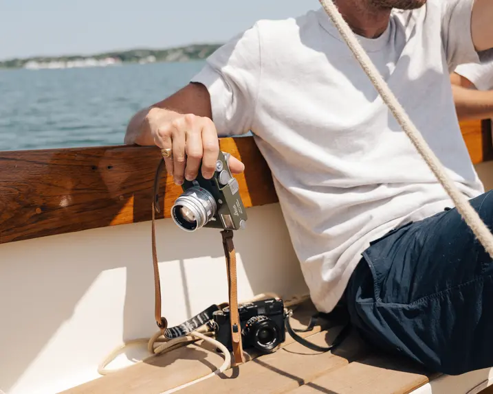 Riley on a boat with his Leica in his hand