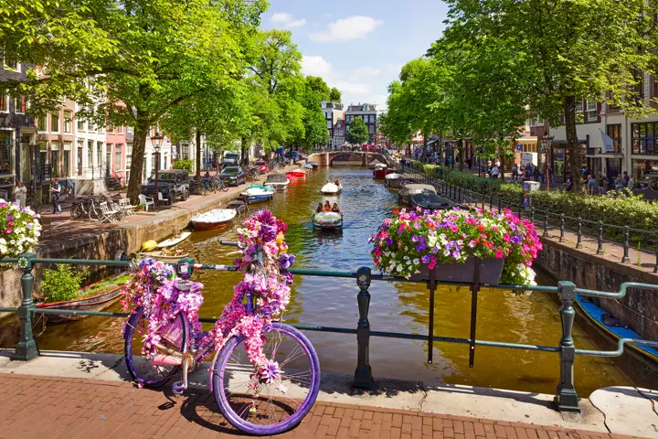 Decorated bike on Amsterdam canal bridge.