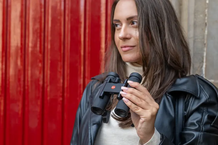 Woman holding her Leica Noctivid Compact