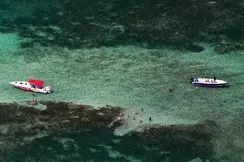 View from above of two boats and people in the water.