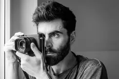 Close-up of a Philipp Weinmann taking a picture with a Leica camera.