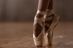 Close-up of a ballerina's feet in ballet shoes. 