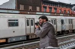 Man photographs a train with a Leica M11