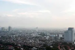 View of a foggy city with tower blocks.