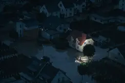 Night shot of a flooded city and rescue workers are in focus.