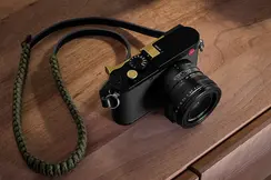 A Leica camera resting on a wooden table
