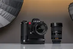 A Leica camera placed on a table in a photography studio setting