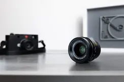 Leica camera with a lens on a table.