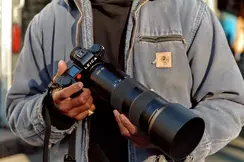 A man holding a Leica camera in his hand