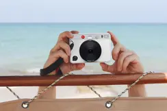 White Leica sofort Camera at the beach