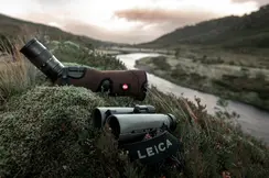 Leica-binoculars-Noctivid-8x42-and-spotting-scope-lying-in-a-meadow-in-the-Scottish-Highlands