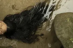Woman with long brown hair laying in the sea