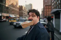 Man with a book in his mouth
