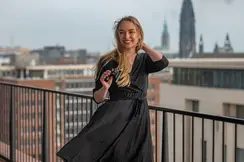 A woman in a black dress holding the Ultravid