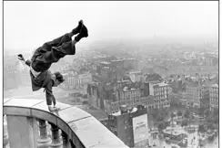 Man doing a handstand on a high banister