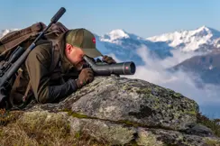 Man is looking through his Televid spotting scope