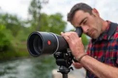 Man is looking through his Leica APO-Televid spotting scope