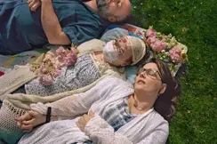 Katie with her family laying in grass