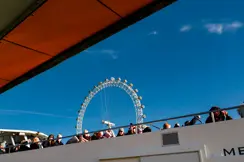 A boat trip on the River Thames in London, with the Ferris wheel visible in the background