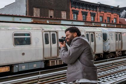 Man photographs a train with a Leica M11