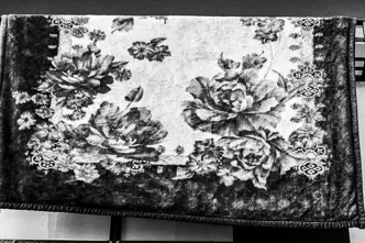 A patterned ceiling hangs over a railing