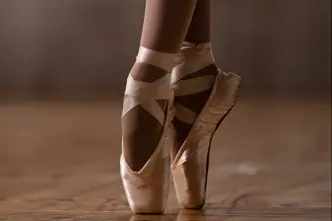 Close-up of a ballerina's feet in ballet shoes. 