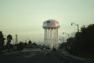 An empty road leads to a water tower labelled ‘Cocoa, Florida’.