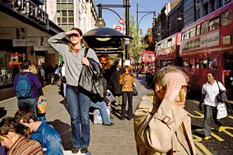 A woman who was standing on a bench, appearing to be looking for something and other people