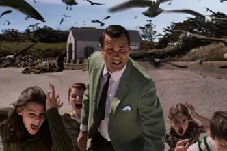 A man and five kids running away from crows 